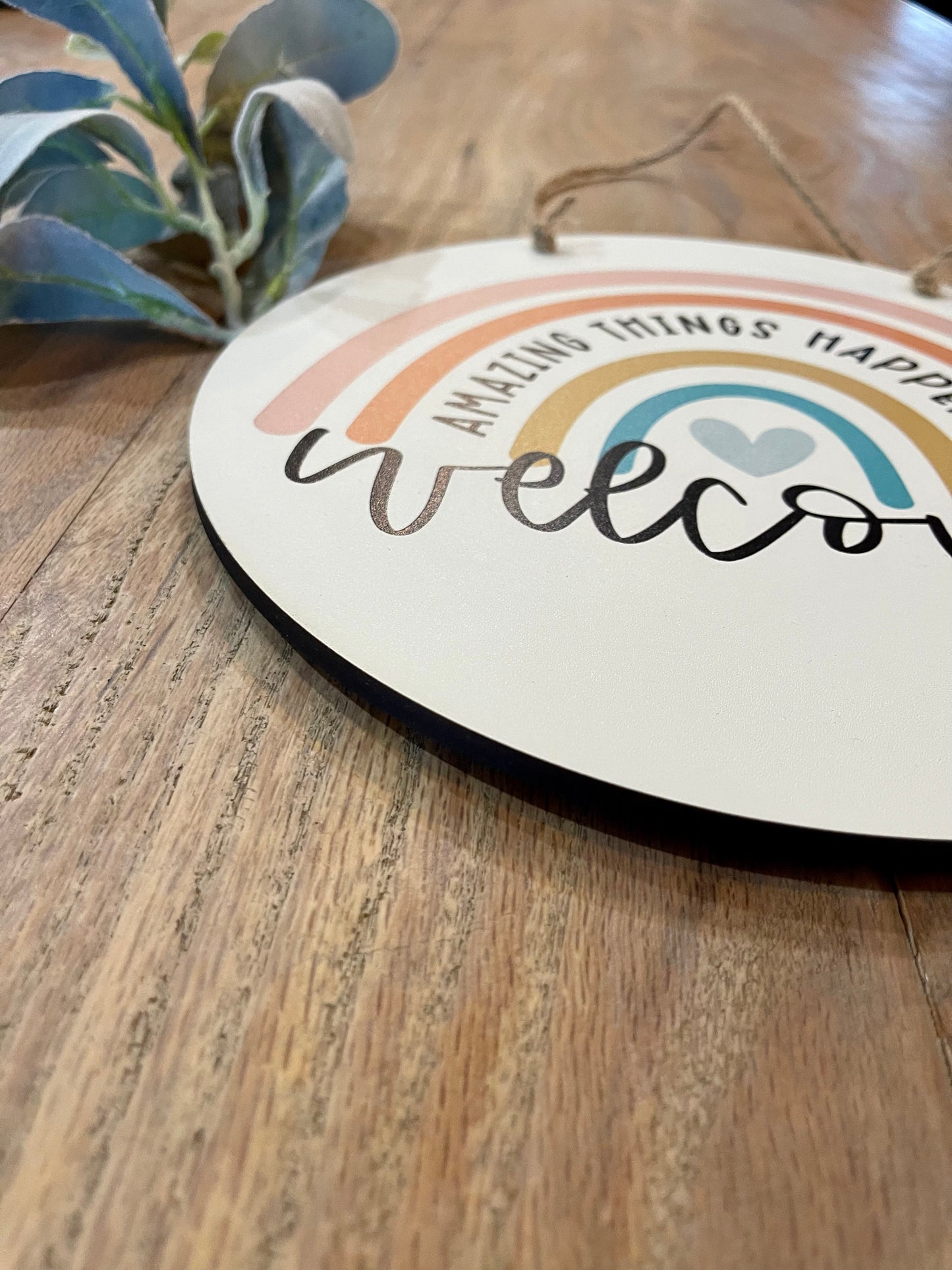 Welcome amazing things happen here hanging circle sign