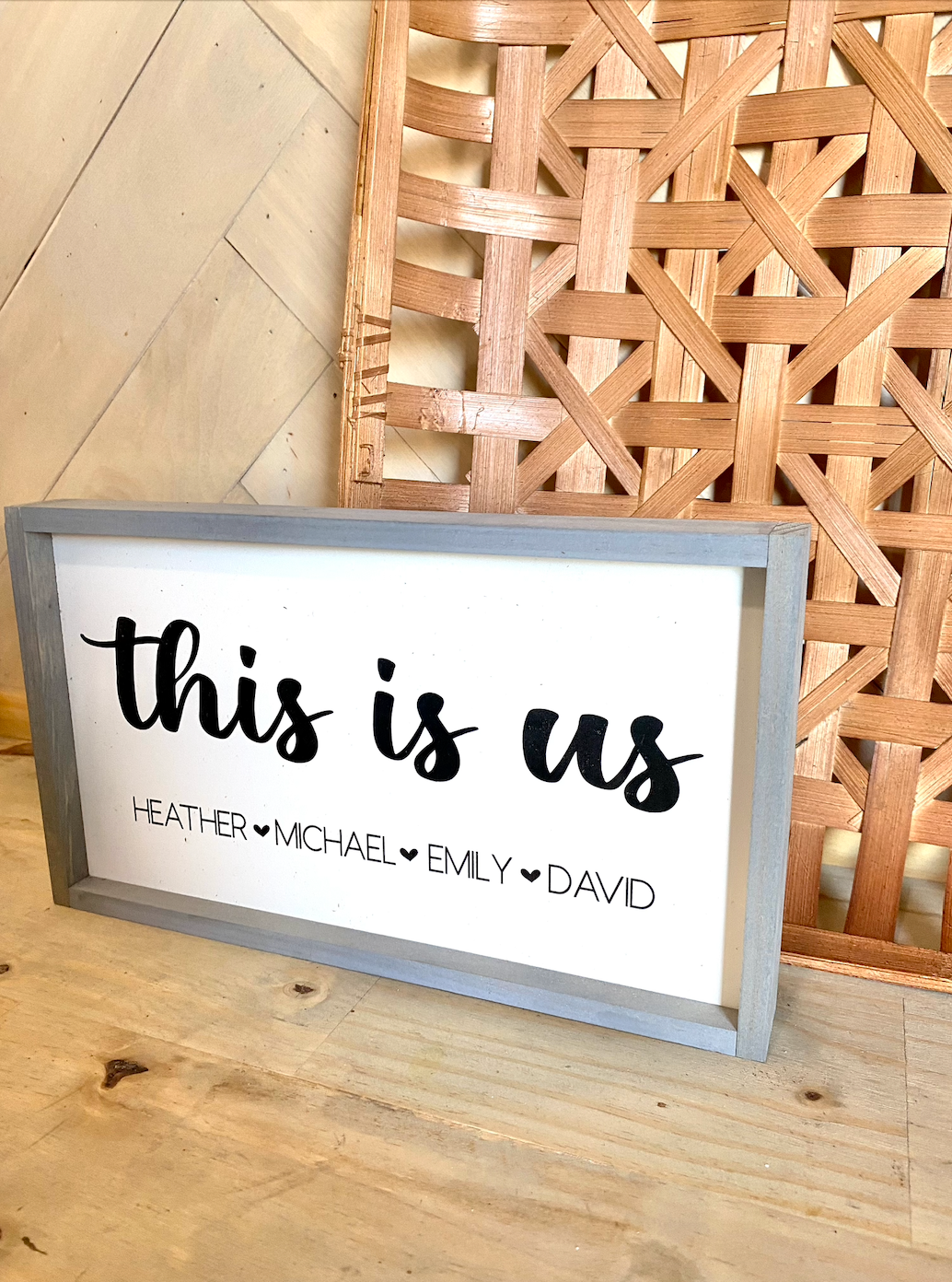 This is us listed family names with heart wood family sign