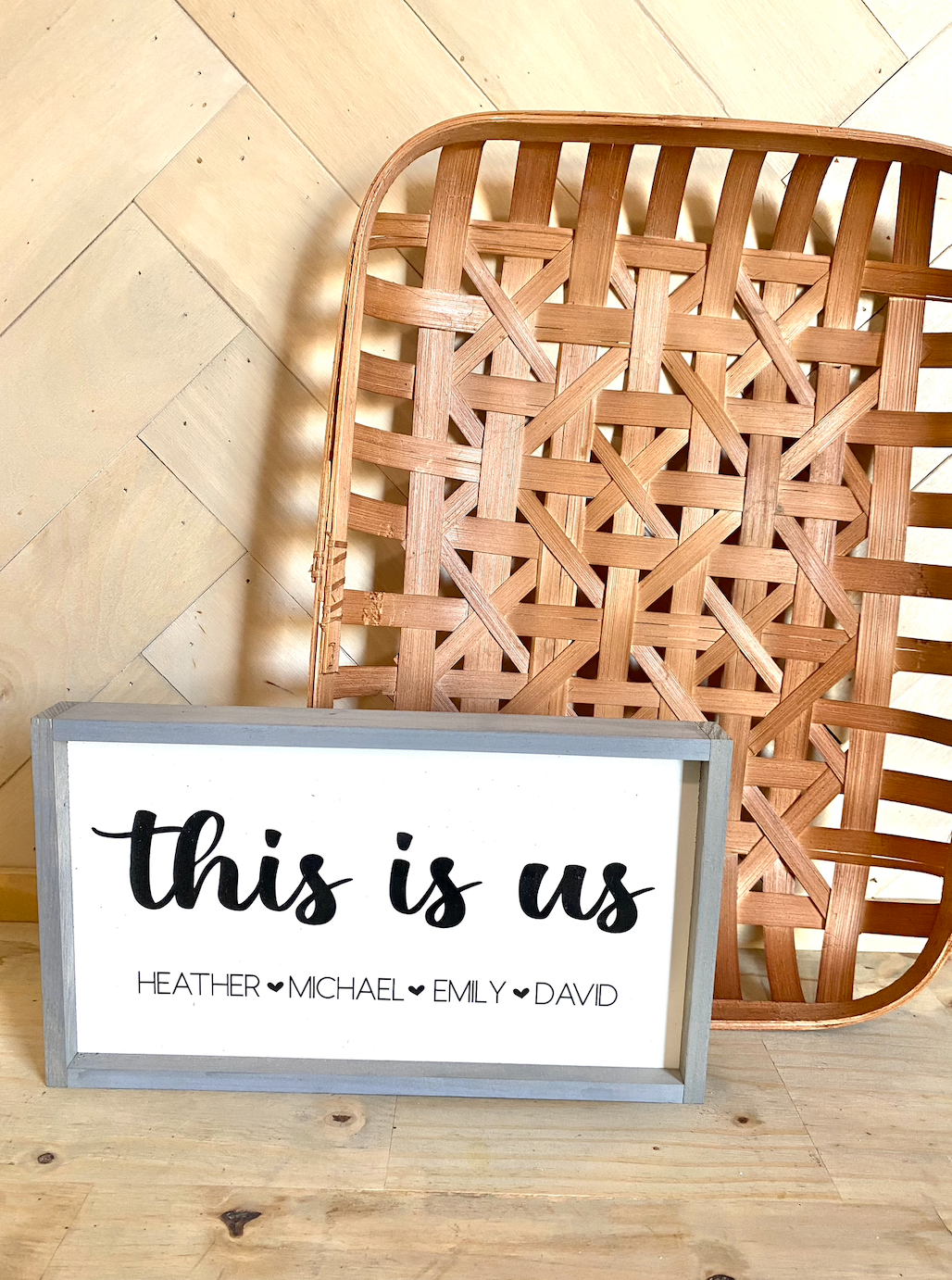 This is us listed family names with heart wood family sign