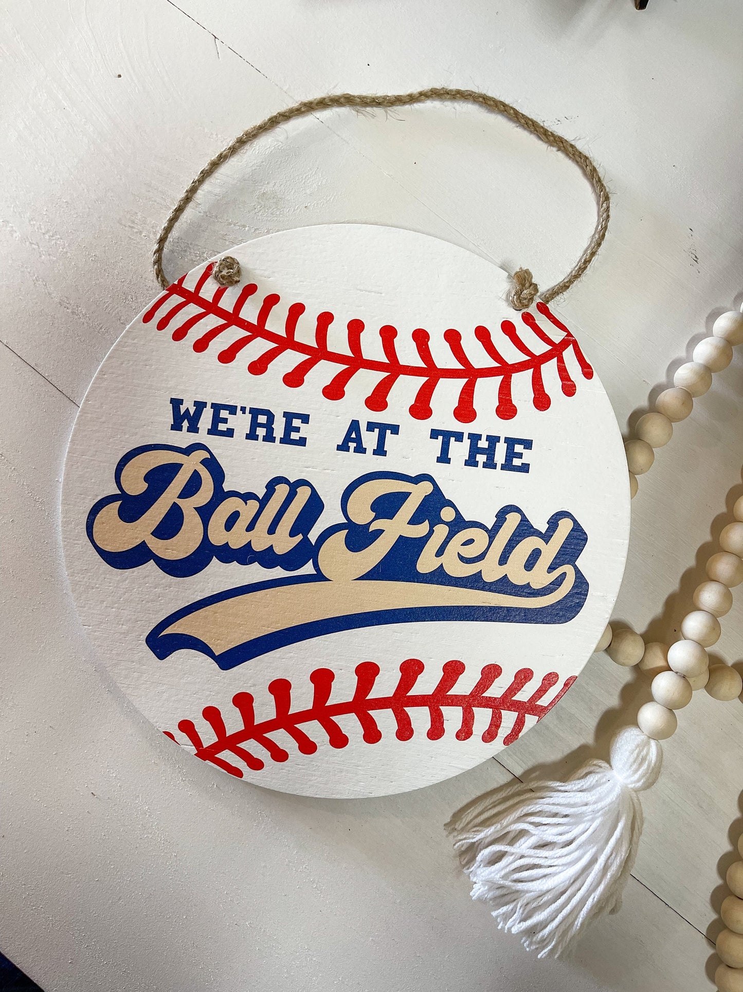 We're at the Ball field Round wood sign Baseball season welcome door hanger